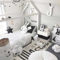 a child's bedroom decorated in white and black