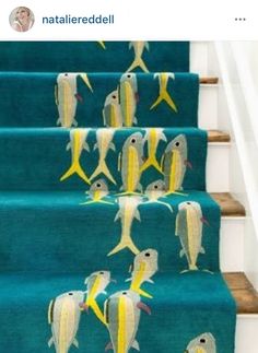 blue carpeted stairs with yellow and white fish on them