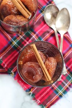 two bowls filled with donuts on top of a red and green checkered table cloth