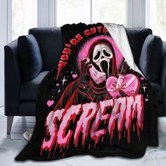 a couch with a blanket on it that says scream