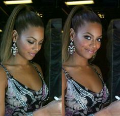 a woman in a black and white dress holding a cell phone with her right hand