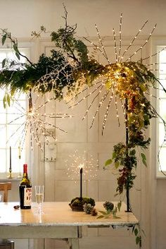 the table is decorated with greenery and lights for an elegant touch to the room