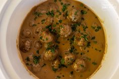 a white bowl filled with meatballs and gravy