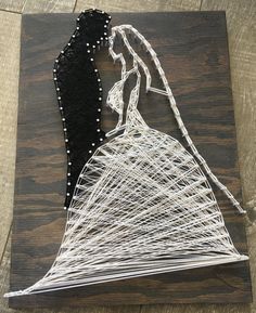 the string art is made to look like a bride and groom