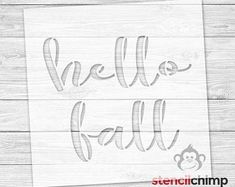 a sign that says hello fall on the side of a wooden wall with a monkey