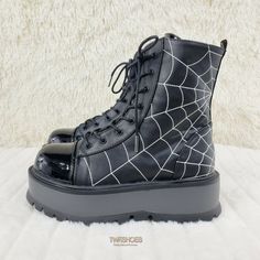 2" (51mm) Platform Lace-Up Front Ankle Boot Black Matte Vegan Upper With White Thread Embroidered Spider Web Design. Toe Cap And Tongue Is Made With Shiny Black Patent Leather. Rubber Tread High Density Cushioned Foot-Bed Women's Sizes: 6-14 Lace-Up Front Ankle Boot Punk Style High-top Synthetic Boots, Punk Style Ankle-high Synthetic Boots, Edgy Black Closed Toe Platform Boots, High-top Platform Boots For Streetwear, Punk Style Synthetic Platform Boots With Round Toe, Black Punk Style Synthetic Platform Boots, Synthetic Round Toe Wedge Boots For Streetwear, Punk Style Synthetic Boots With Round Toe, Black Grunge Lace-up Boots With Chunky Platform