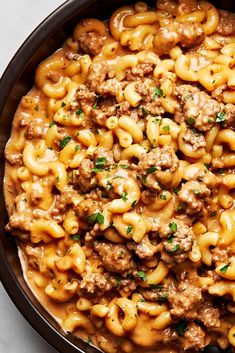 a bowl filled with macaroni and cheese on top of a table