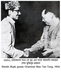 two men shaking hands with each other in front of a black and white photo,