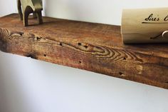 a wooden shelf with a rolled up piece of paper on it