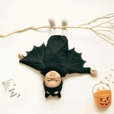 an overhead view of a child's halloween costume and pumpkins on the table