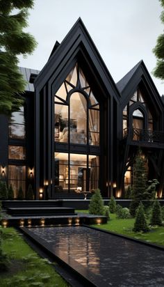 a large black house with lots of windows on it's sides and trees in the front yard