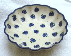 a blue and white bowl sitting on top of a counter next to a towel covered floor