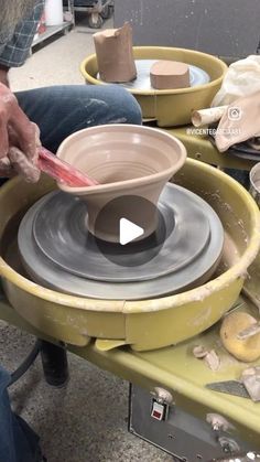 a man is making pottery on a wheel