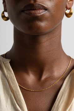 The Small Solo Chain features single woven links joined by a Mycenae-inspired fibula clasp, a.k.a. the first safety pin. 22K Yellow Gold Made in NYC Gold-plated Figaro Chain Link Jewelry, Adjustable Minimalist 14k Gold-filled Chain Necklace, Black Gold-plated Adjustable Chain Jewelry, Gold Safety Pin Jewelry With Adjustable Chain, Adjustable Brass Chain Necklace, Tarnish Resistant, Chain Loop, Safety Pin, 22k Gold, A K