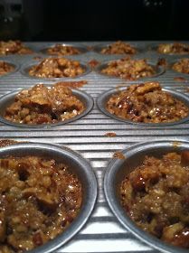 muffin tins filled with baked goods sitting on top of a metal rack in an oven