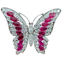 Vintage Ruby and Diamond Butterfly Brooch in Platinum and White Gold, 1990s. This brooch is modelled as a butterfly in flight, the winds decorated with marquise mixed-cut Burmese rubies and round brilliant-cut diamonds in an openwork design further accented with millegrain decoration, the body and head pave-set throughout with round brilliant-cut diamonds and accented with cabochon ruby eyes and diamond-set antennae. This brooch is made in platinum and is secured to reverse with a white gold hin Luxury Butterfly Brooch Jewelry, Luxury Antique Carved Brooches, Luxury Art Deco Brooches With Cabochon, Butterfly In Flight, Pink Brooch, Cabochon Ruby, Butterfly Fashion, Diamond Butterfly, Dragonfly Jewelry