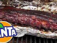 ribs are cooking on the grill with an anta logo over it's left side