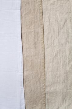 three pieces of white linen are lined up against each other