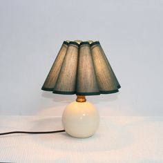 a table lamp sitting on top of a white surface