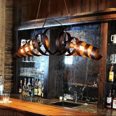 a bar with several wooden barrels hanging from the ceiling