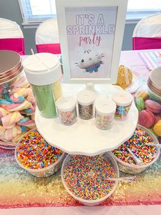 an assortment of sprinkles and confetti displayed on a cake stand