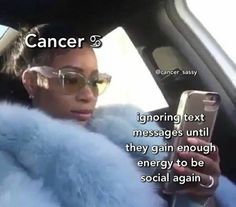 a woman sitting in the back seat of a car while looking at her cell phone