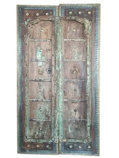 an old wooden door with ornate carvings on the front and side panels, painted green