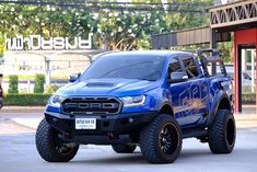 a blue truck parked in front of a building