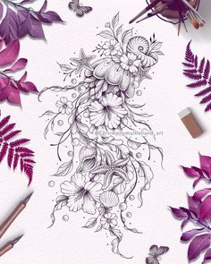 some purple flowers and leaves on a white surface with pencils, markers and paper