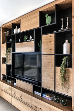 an entertainment center made out of wood and metal with plants on the shelves, in hebrew text