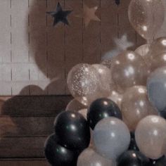 black and white balloons are in front of a wall with stars on the back ground