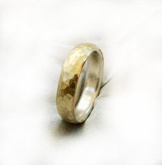 a wedding ring is shown on a white surface