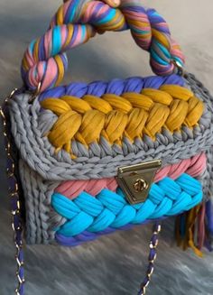 a multicolored handbag hanging from a chain