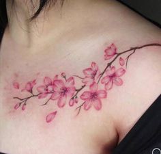 a woman's chest with pink flowers on it