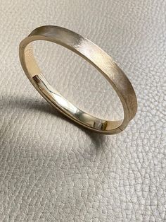 A beauty! 14k gold textured hinged bangle bracelet - 6.9 inch interior A beautiful vintage hollow-form bangle bracelet in 14k gold. She has a concave exterior that has been hand finished with a sublime cross-hatch texture. Bangle interior has a high polish for comfort and visual contrast.    Details  * 12.1g  * 14k gold (not fill or plated)  * Interior oval measures 2 inches (52mm) x 2.4 inches (60mm)  * 6.9 inch interior size approximate  * Hallmark with 14k inside heart outline   * 8mm wide  * Well working clasp with secure safety  * Very good condition with normal age related wear This listing is for 14k textured bangle only. Other bracelets are for inspiration and are sold separately [in my shop here](https://www.scabbyrobot.com/collections/jewelry-box "My jewelry box")   Not sure it w Formal Yellow Gold Hammered Bangle, Elegant Formal Hammered Bangle, Elegant Formal Hammered Cuff Bracelet, 14k Gold Hinged Bangle Bracelet, Elegant 14k Gold Hammered Bracelet, 14k Gold Hinged Bangle, 14k Gold Hinged Bangle For Wedding, Hammered Yellow Gold Bangle For Anniversary, Formal 14k Gold Bangle Stamped 14k