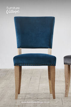 a blue chair sitting on top of a hard wood floor