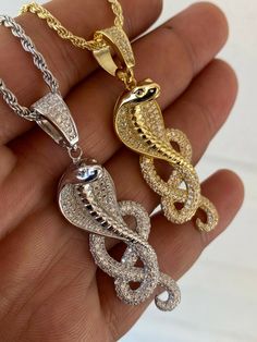 "Gorgeous handmade king cobra snake medallion 0.66\" x 1.75\" (2.25\" w. bale) Solid 925 sterling silver...we have it in natural silver rhodium plated (white color) or 14k gold plated over silver Doesnt turn green or change color...gold lasts many years as its bonded to real silver underneath! Stamped 925 Pendant weighs 11.5 grams! VERY DETAILED. Amazing handmade piece Super Icy high grade simulated diamonds (CZ) You can buy pendant alone or with choice of 2mm solid 925 silver rope chain. Chain King Cobra Snake, Jewelry Rings Unique, Cobra Snake, King Cobra, Mens Gold Jewelry, Snake Pendant, Gold Chain With Pendant, Snake Jewelry, White Gold Chains