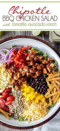 a white plate topped with chicken salad next to tortilla chips and avocado