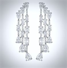 A delightfully unique pair of bridal earrings with an incredible sparkle! Adorned with flawlessly faceted cubic zirconia that capture the light in a dazzling array of sparkles, the earrings are rhodium plated for a bright finish which enhances the intricate detailing and conveys a modern take on old elegance. Overall length of the earring is 52mm (approx. 2"). Hypoallergenic - lead, nickel and cadmium free. This exquisite design will add a touch of sophistication to any wedding gown or formal en Luxury Statement Bridal Earrings With Cubic Zirconia, Luxury Dazzling Cubic Zirconia Earrings, Luxury Cubic Zirconia Bridal Earrings With Halo Setting, Luxury Polished Cubic Zirconia Earrings, Luxury Cubic Zirconia Earrings With Plating, Luxury White Cubic Zirconia Bridal Earrings, Luxury Cubic Zirconia Earrings, Luxury Cubic Zirconia Earrings For Gift, Luxury Modern Cubic Zirconia Jewelry