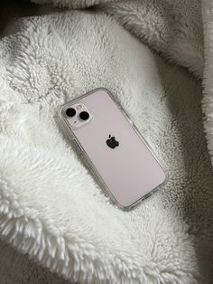 an iphone case sitting on top of a white blanket