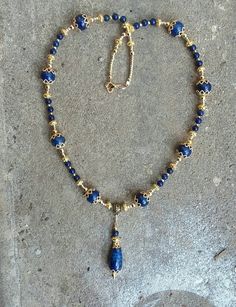 Made of gold-plated filigree findings and lapis lazuli stone, this necklace looks striking in sunlight!  Necklace is 20in.this can come with earrings to match! Elegant Blue Brass Necklace, Bohemian Gold Lapis Lazuli Necklace, Elegant Gold Beaded Necklaces With Lapis Lazuli, Elegant Beaded Lapis Lazuli Necklace, Gold Lapis Lazuli Spiritual Necklace, Gold Lapis Lazuli Necklaces For Jewelry Making, Handmade Elegant Lapis Lazuli Beaded Necklaces, Gold Necklaces With Lapis Lazuli Gemstone Beads, Gold Lapis Lazuli Necklace With Gemstone Beads