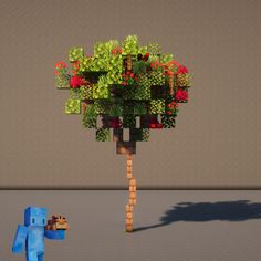 an image of a tree with flowers on it and a blue dog in the foreground