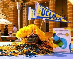 a bunch of yellow flowers sitting on top of a table next to a book and umbrella