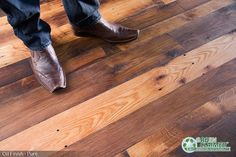 a person standing on top of a wooden floor