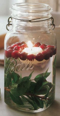 a glass jar filled with water and candles