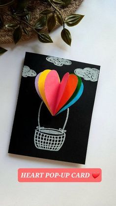 a heart - shaped card with the words heart pop up card next to it