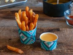 french fries and dipping sauce on a wooden table