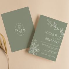 two wedding cards on top of each other next to a flower vase with a plant in it