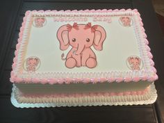 a pink and white cake with an elephant on it