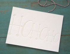 a white greeting card with the word holohoo on it next to a string